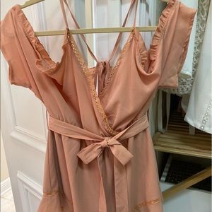 Nude/light peach romper with tie belt.
